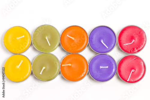 Colorful spa candles isolated on white.