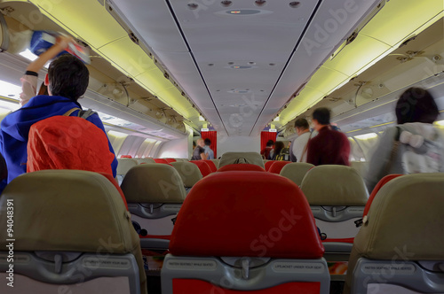 defocus interior of the airplane.passenger passing