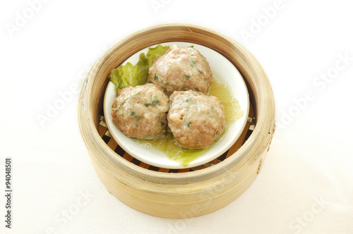 Steamed beef balls. yumcha. dim sum in bamboo steamer with chinese bun, pao, bao zi, steamed dumpling, shumai on table in chinese restaurant. chinese cuisine. 