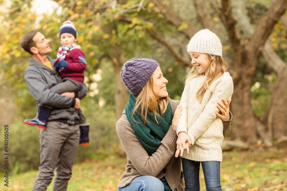 Smiling woman with her daughter against her husband and her son Smiling woman with her daughter against her husband and her son