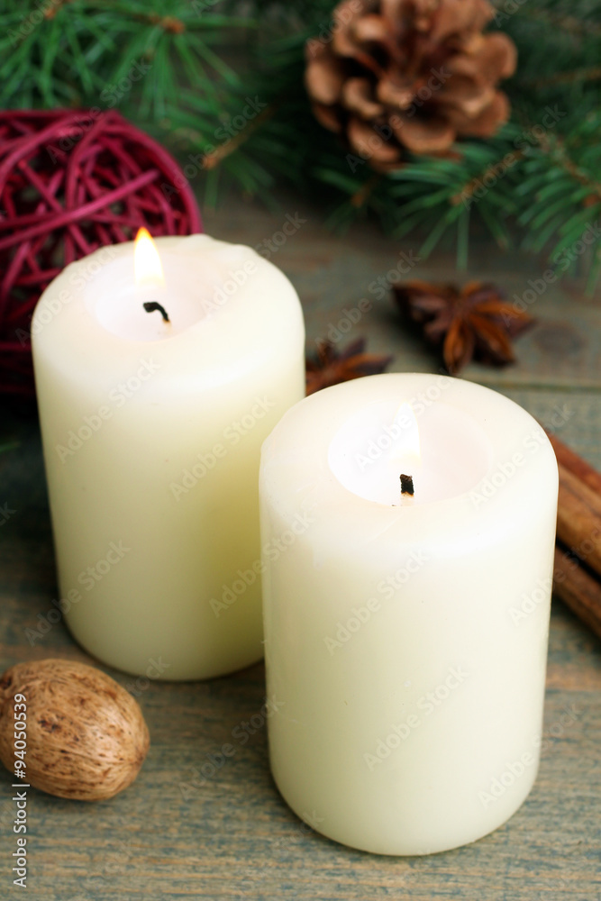 candle with Christmas decoration and spices on wooden brown background, close up, Christmas composition. candle with Christmas decoration and spices on wooden brown background, close up, Christmas composition.