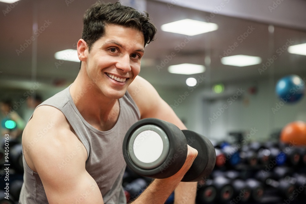 Smiling man lifting dumbbell weight Smiling man lifting dumbbell weight