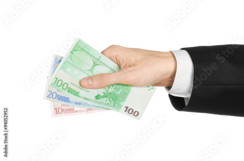 Money and business topic: hand in a black suit holding banknotes 10,20 and 100 euro on white isolated background in studio