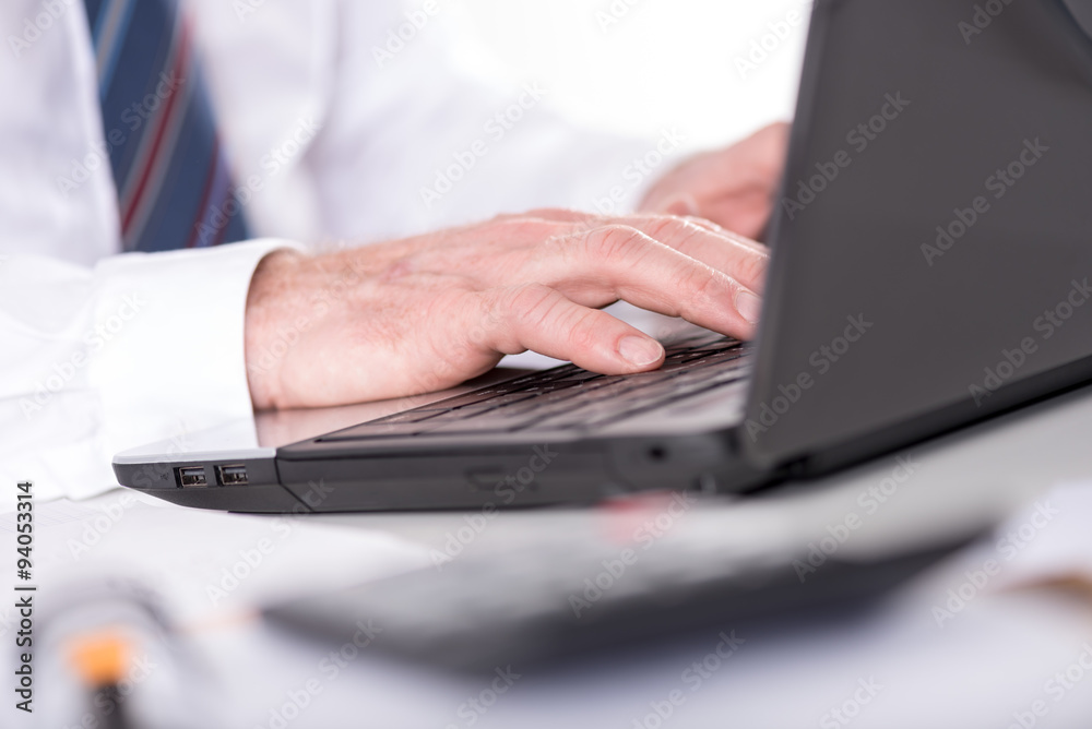 Businessman typing on laptop computer Businessman typing on laptop computer