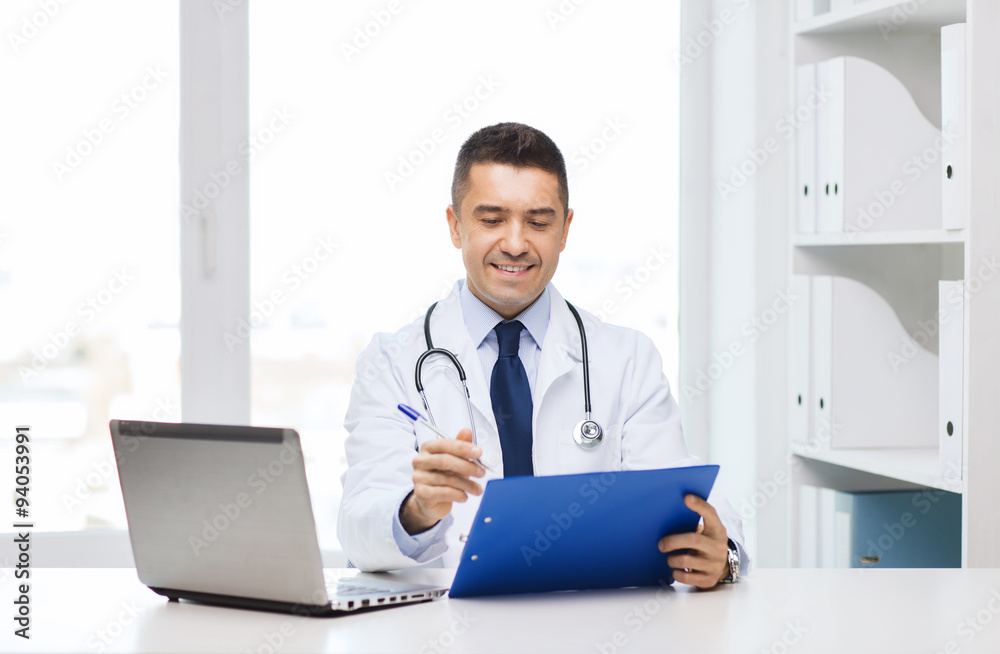 happy doctor with clipboard and laptop in office happy doctor with clipboard and laptop in office