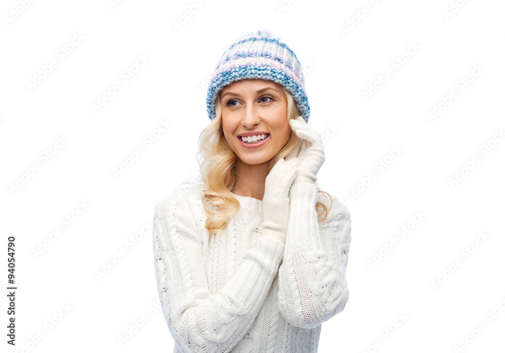 smiling young woman in winter hat and sweater smiling young woman in winter hat and sweater