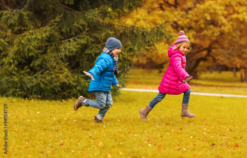 group of happy little kids running outdoors