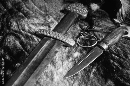 Viking sword and knife on a fur photo