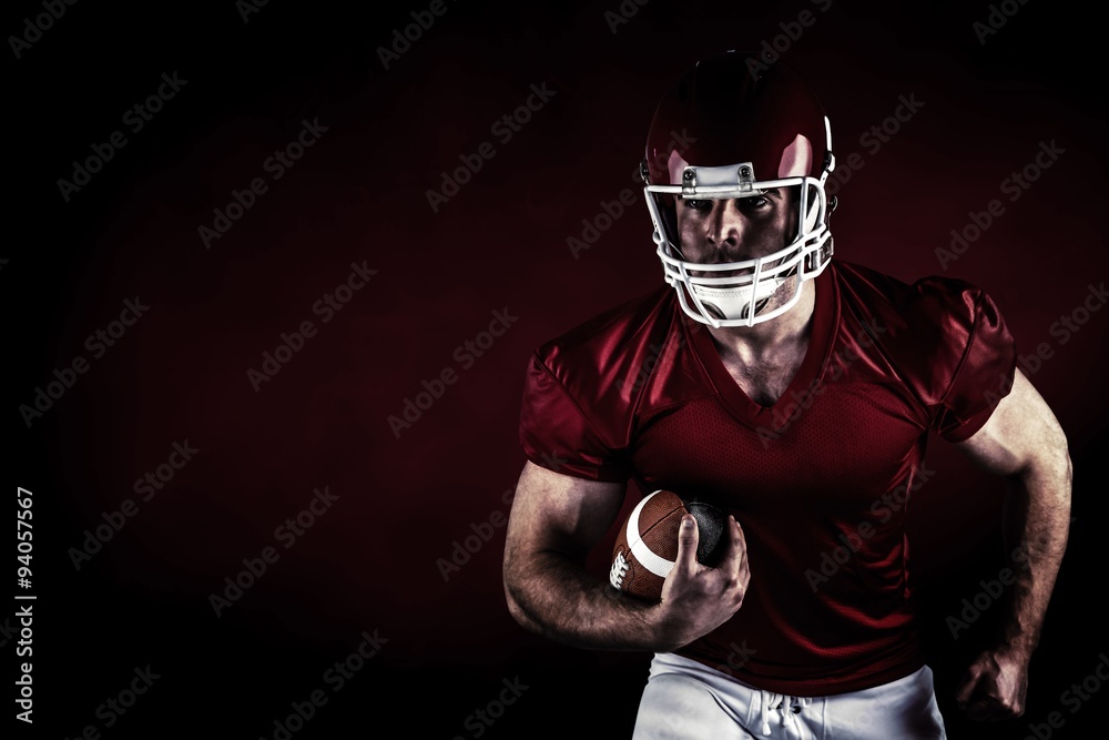 Composite image of american football player holding ball