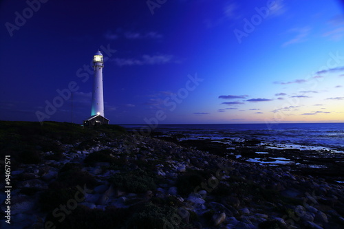 To the lighthouse / An evening view of the Slangkop Lighthouse with rocks and clouds