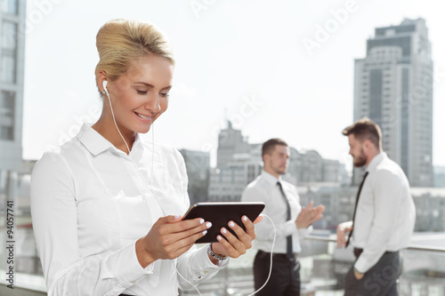 Attractive businesswoman using tablet outdoor