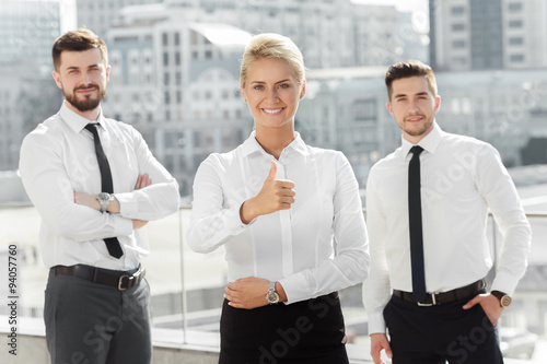 Three confident business partners near office