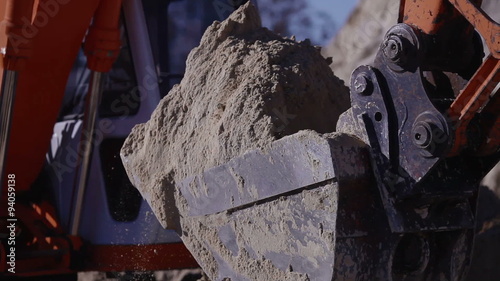 Excavator is digging the ground, sand