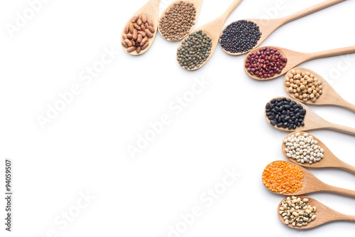 various dried legumes in wooden spoons photo