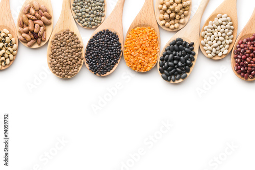 various dried legumes in wooden spoons