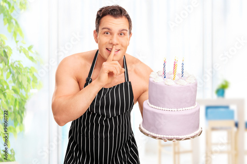 Naked man holding a birthday cake photo