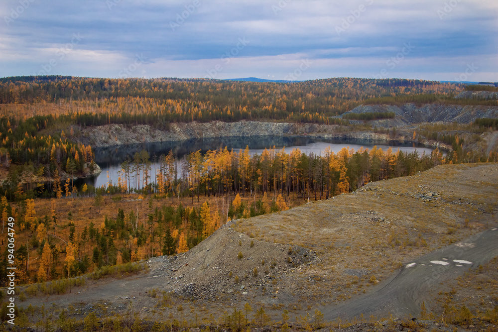 View of the dumps and flooded quarry near the town of Nizhny Tagil, Sverdlovsk region, autumn