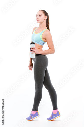 Young sportswoman on tiptoe with bottle of water © Drobot Dean