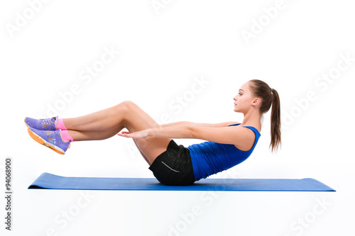 Young sportswoman in sportwear doing exercises