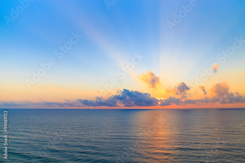 Sunset casting beams of light into the air