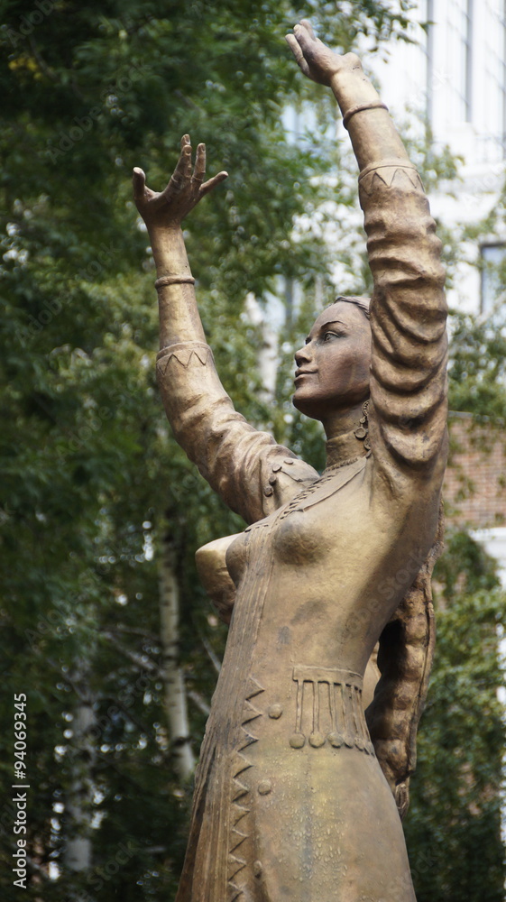 Fototapeta premium Photo of a statue of dancing woman in national costume at the fountain in Ufa, Bashkortostan