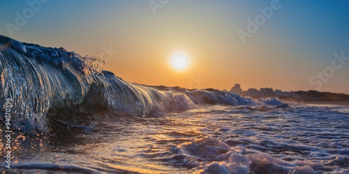 Magic wave splash close-up, at sunset. In Portugal, the Algarve area.
