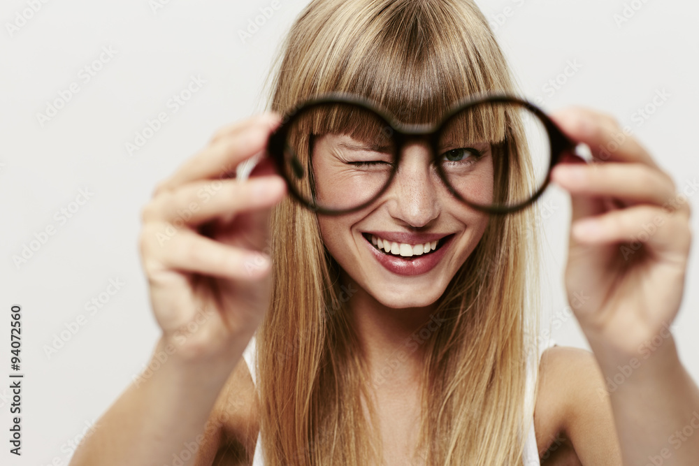 Blond woman in focus with spectacles Blond woman in focus with spectacles
