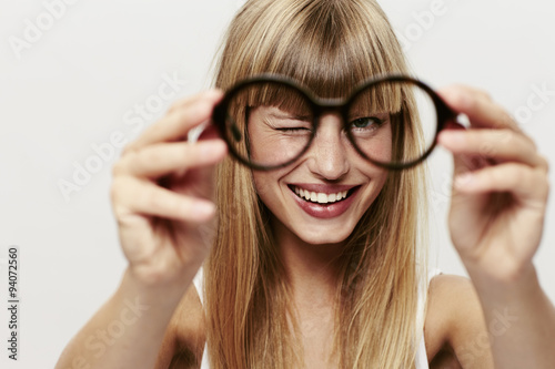Blond woman in focus with spectacles