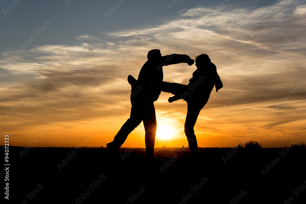 People Silhouette / Two men fighting in the sunset   