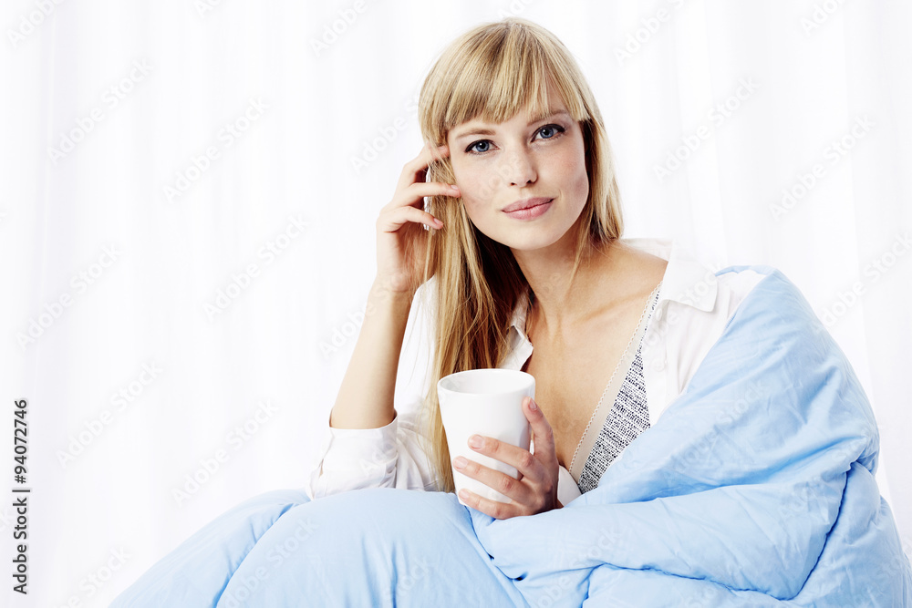 Morning coffee in bed for young blond woman, portrait Morning coffee in bed for young blond woman, portrait