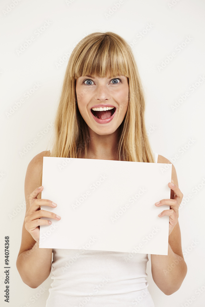 Excited young blond woman with message, portrait Excited young blond woman with message, portrait