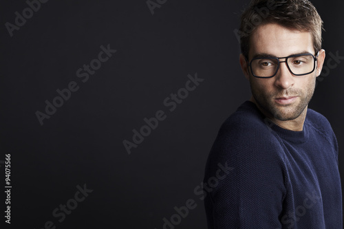 Fototapeta Naklejka Na Ścianę i Meble -  Pensive man looking away in spectacles