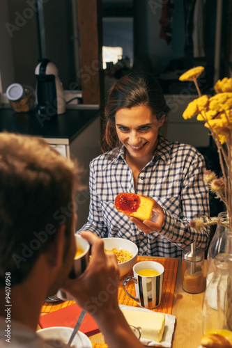 Young Couple Having Breakfast in a Rustic Apartment photo