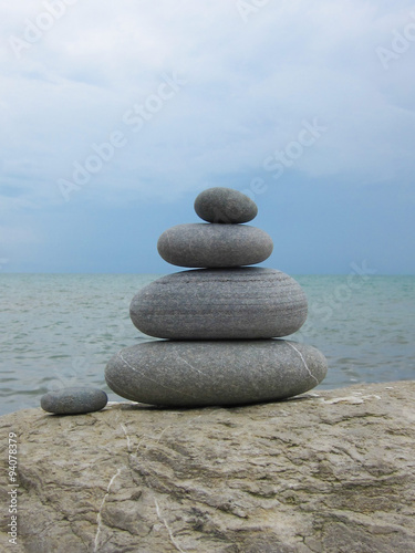 A composition of five stones on a rock against the background o
