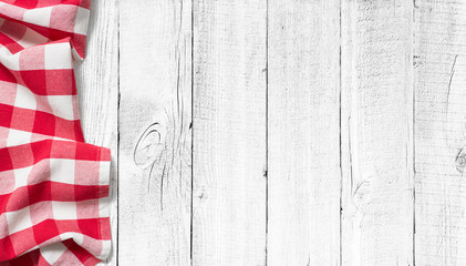 red picnic tablecloth on white wood table background