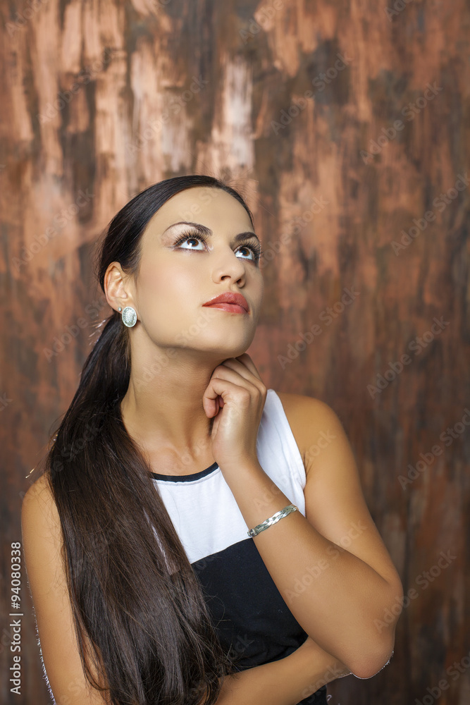 Fototapeta premium Beauty portrait of young brunette woman, isolated on gray backgr