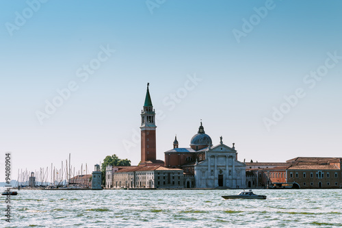 Venice cityscape with boats and traditional buildings. San Giorgio Maggiore church in Venice, Italy, Europe.