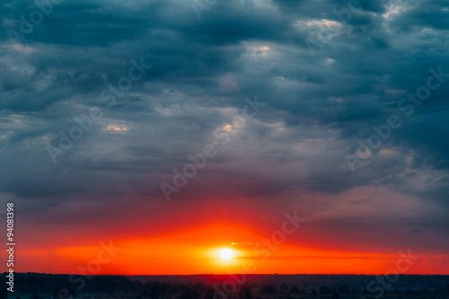 Dramatic Sky With Sunrise Sun Over Forest, Meadow © Grigory Bruev