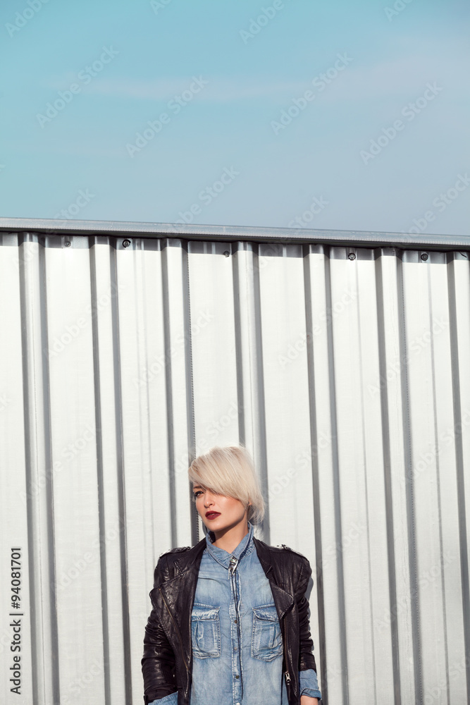 Fototapeta premium young punk style blond lady leaning on wall