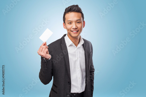 portrait of young asian man showing a visit card