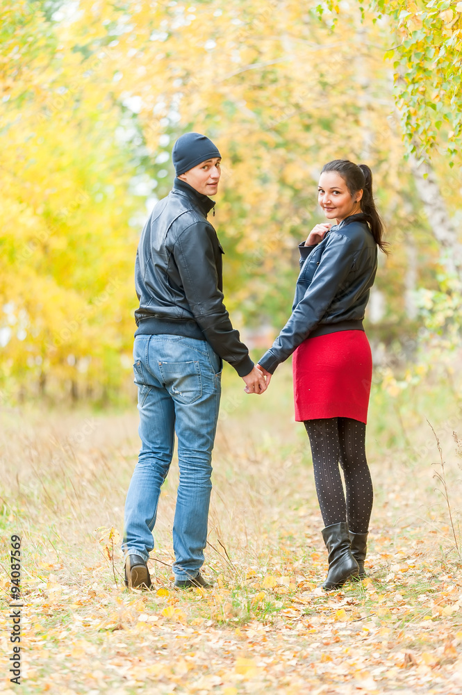 Young romantic couple walks in autumn forest Young romantic couple walks in autumn forest