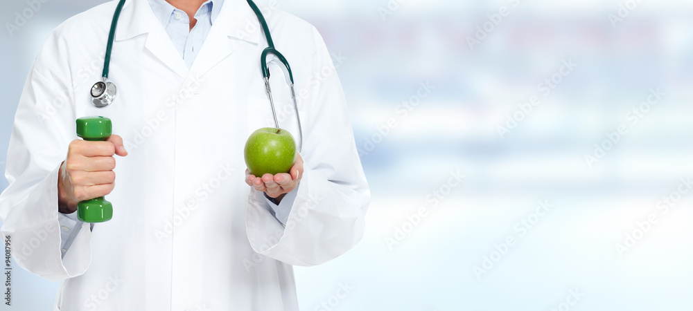 Doctor woman with dumbbell and apple. Doctor woman with dumbbell and apple.