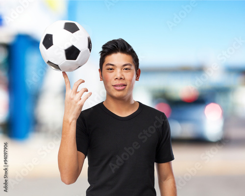 happy chinese-sport-man with soccer-ball © asierromero