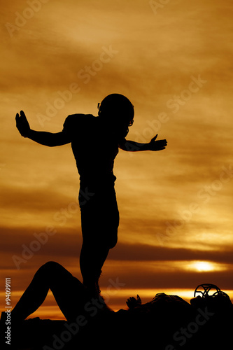 silhouette of a football player after a tackle Stock Photo