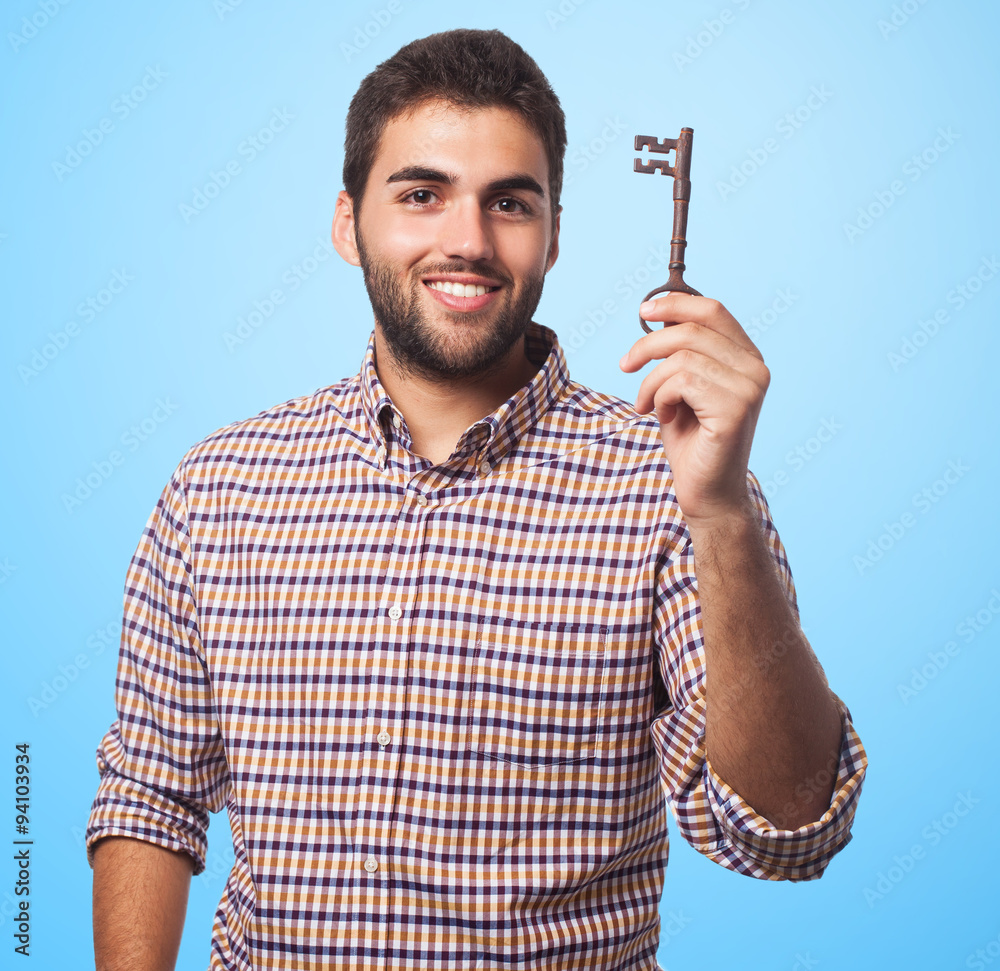 portrait of a young man holding an old key portrait of a young man holding an old key