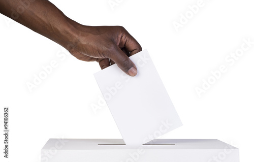 
Ballot box with person casting vote on blank voting slip