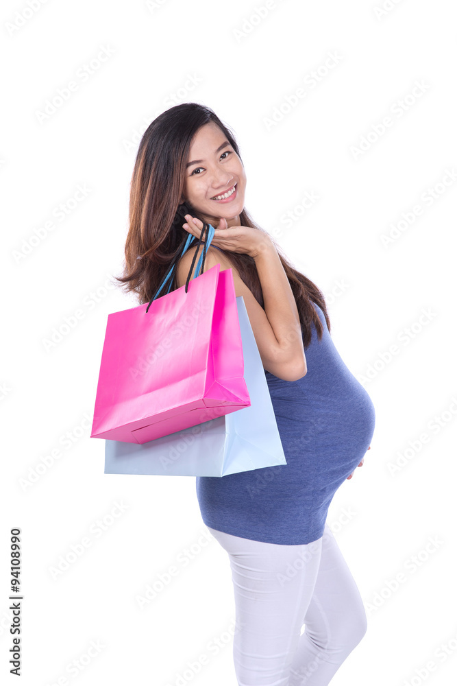 Asian Pregnant woman holding paper bag, shopping concept in whit Asian Pregnant woman holding paper bag, shopping concept in whit