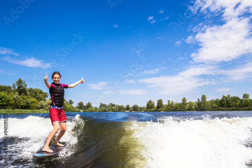 Girl rides a study wakesurfing photo