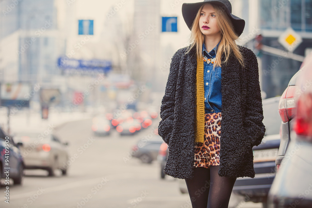 Fashionable young woman posing outside in a city street. Winter Fashion Fashionable young woman posing outside in a city street. Winter Fashion