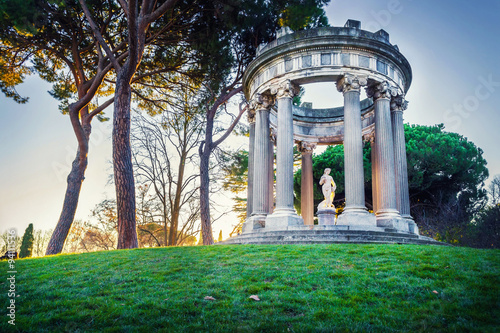 classical monument in a park at sunset hour